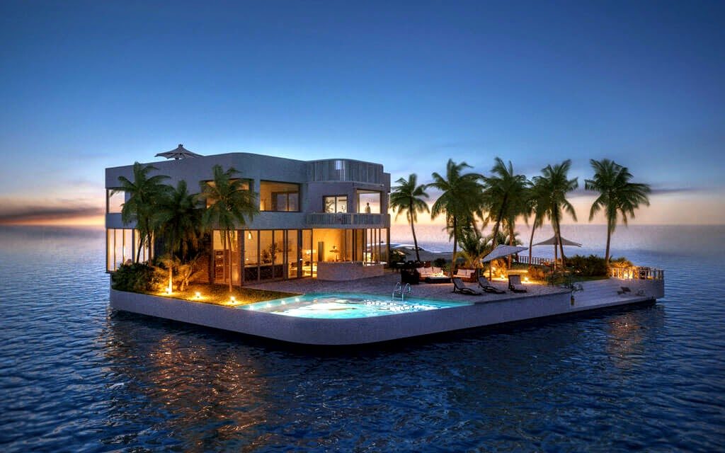 A luxurious floating home is surrounded by calm ocean waters at sunset. The modern structure features large windows, a swimming pool with loungers, and is adorned with vibrant lighting. Tropical palm trees line the house, adding a serene and exotic atmosphere. | MONEY6X