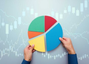 A person's hands arranging a multicolored pie chart against a background featuring financial graphs and stock market candlestick charts, highlighting the importance to diversify your portfolio with segments in green, red, blue, and yellow. | MONEY6X