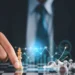 A person in a suit moves a golden chess piece on a chessboard. Silver pieces are toppled over. A transparent graph with rising arrows and bar charts overlays the image, suggesting strategic planning or financial growth, much like the careful strategy required in investing. | MONEY6X