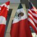 Flags of Canada, Mexico, and the United States are displayed side by side. The Canadian flag features a red maple leaf, the Mexican flag shows an eagle with a snake, and the American flag has stars and stripes, symbolizing unity amid past disputes like the Trump tariffs. | MONEY6X