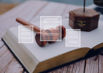 Open book on a wooden table with a gavel resting atop, symbolizing the legal steps to prove wrongful death. Overlay of document icons suggests judicial themes. A wooden box is blurred in the background, enhancing the scholarly ambiance. | MONEY6X