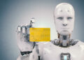 A humanoid robot, illustrating how AI is making casino payments faster, holds a yellow credit card in its right hand. It showcases a sleek silver-white design with visible joints and facial features, set against a light gray background. | MONEY6X