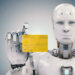 A humanoid robot, illustrating how AI is making casino payments faster, holds a yellow credit card in its right hand. It showcases a sleek silver-white design with visible joints and facial features, set against a light gray background. | MONEY6X