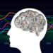 Silhouette of a human head with a brain filled with 100-dollar bills, set against a background of colorful financial line graphs.