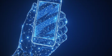 A digital illustration of a hand holding a smartphone, both formed by glowing blue lines and dots representing a network or futuristic technology on a dark background. | MONEY6X