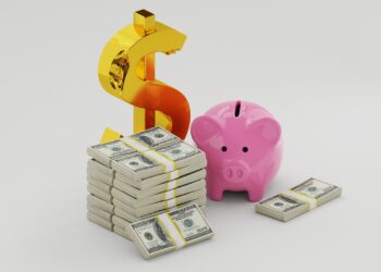 A pink piggy bank, a large gold dollar sign, and several stacks of U.S. hundred-dollar bills are arranged on a plain white background, symbolizing saving and financial growth. | MONEY6X